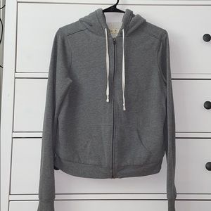 A Gray fuzzy Holister zip up sweater